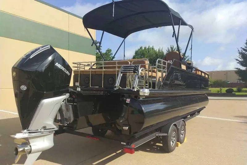 Slide: The Image of 2025 Regency 250 LE3 Sport pontoon boat with Mercury outboard engine, parked outdoors. - 4