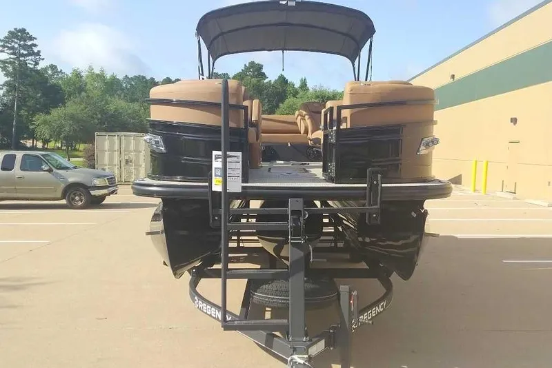Slide: The Image of 2025 Regency 250 LE3 Sport pontoon boat on trailer in parking lot. - 6