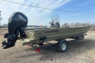 Slide: The Image of 2025 Tracker Grizzly 2072 CC boat on trailer, outdoor setting, clear sky. - 10