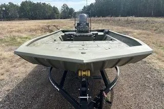 Slide: The Image of 2025 Tracker Grizzly 2072 CC boat on trailer in outdoor setting. - 13