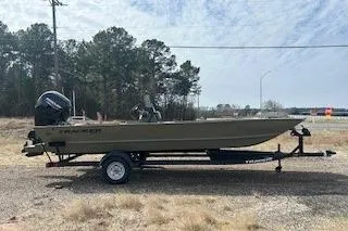 Slide: The Image of 2025 Tracker Grizzly 2072 CC boat on trailer, parked outdoors. - 14