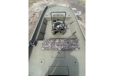 Slide: The Image of 2025 Tracker Grizzly 2072 CC boat interior with camouflage seating and steering console. - 7