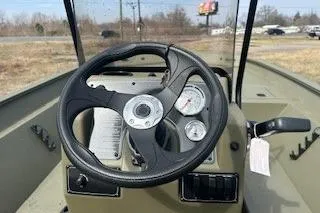 Slide: The Image of 2025 Tracker Grizzly 2072 CC boat dashboard with steering wheel and gauges. - 8