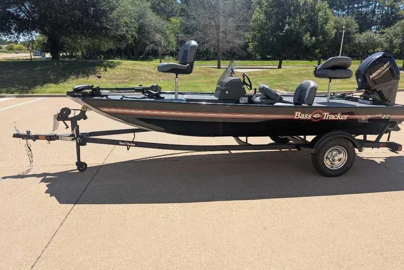 Slide: The Image of 2025 Tracker Bass Tracker Classic XL boat on trailer, parked outdoors. - 17