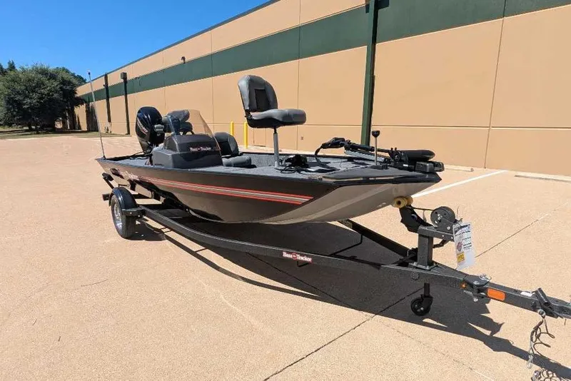 Slide: The Image of 2025 Tracker Bass Tracker Classic XL boat on trailer, parked outdoors. - 4