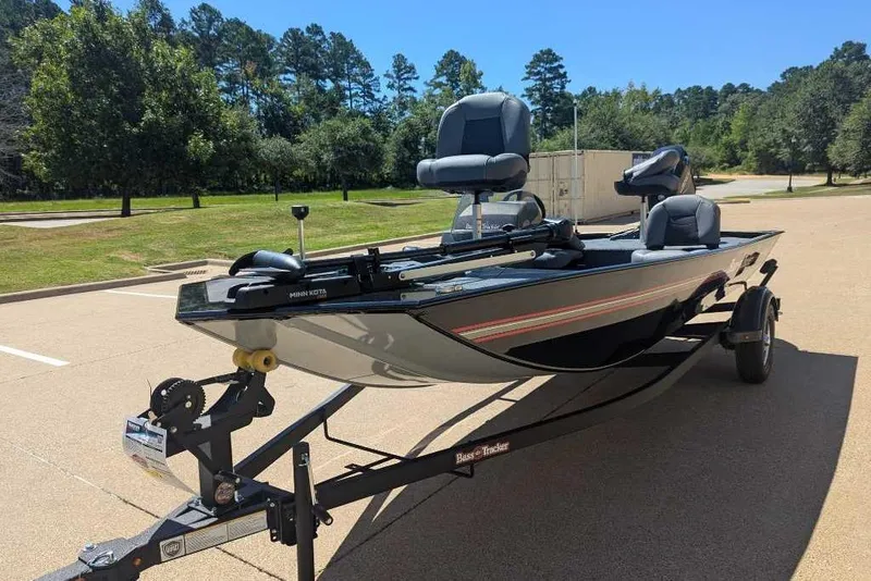 Slide: The Image of 2025 Tracker Bass Tracker Classic XL boat on trailer in sunny parking lot. - 8