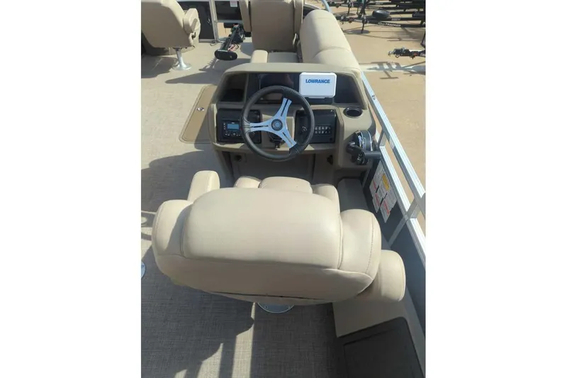 Slide: The Image of 2025 Sun Tracker Sportfish 24 XP3 boat interior with steering console and beige seating. - 10