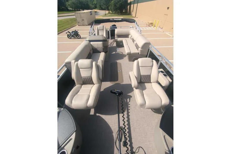 Slide: The Image of 2025 Sun Tracker Sportfish 24 XP3 pontoon boat interior with beige seating and spacious layout. - 12