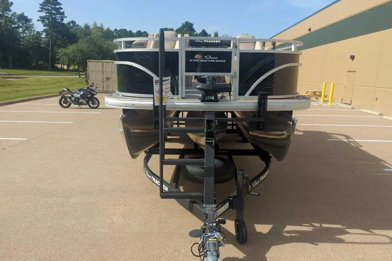 Slide: The Image of 2025 Sun Tracker Sportfish 24 XP3 pontoon boat on trailer in parking lot. - 3