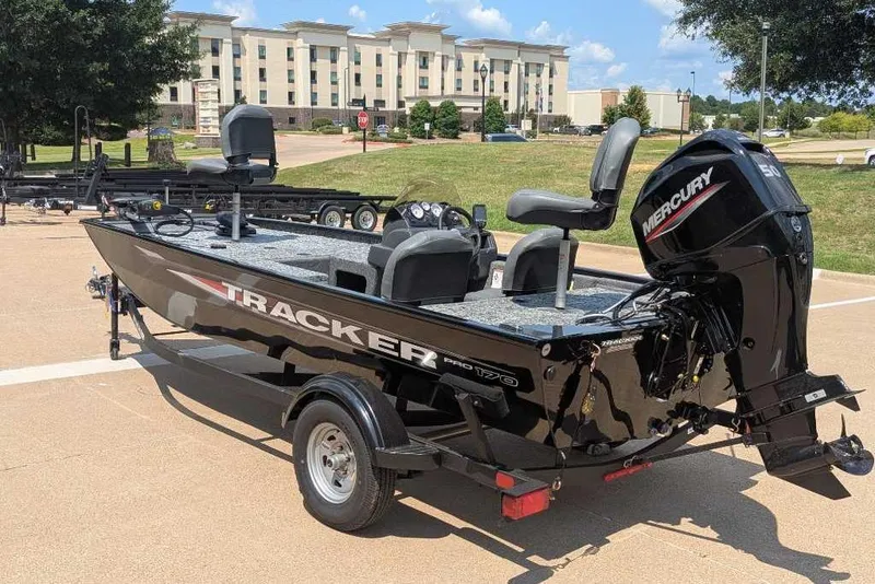 Slide: The Image of 2026 Tracker Pro 170 boat with Mercury engine, parked outdoors on a sunny day. - 5