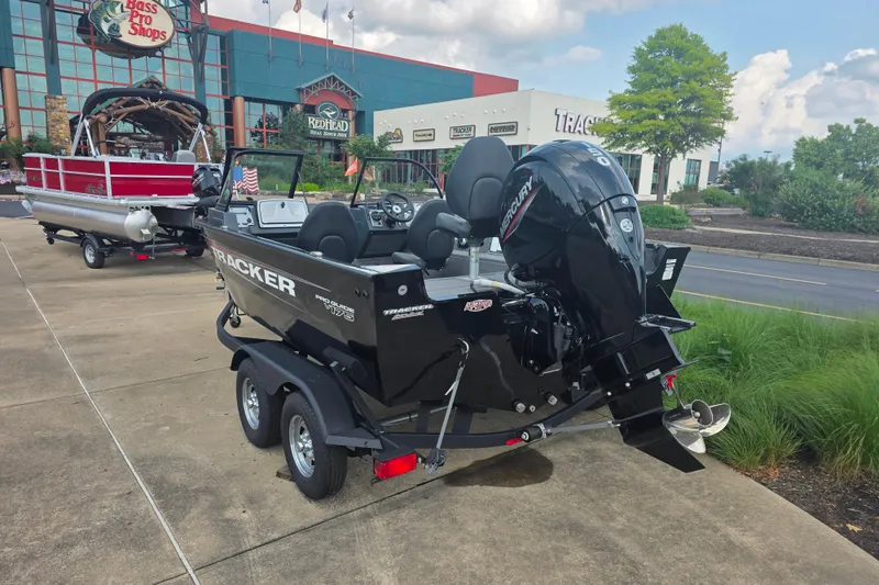 Slide: The Image of 2026 Tracker Pro Guide V-175 Combo boat on trailer outside Bass Pro Shops. - 3