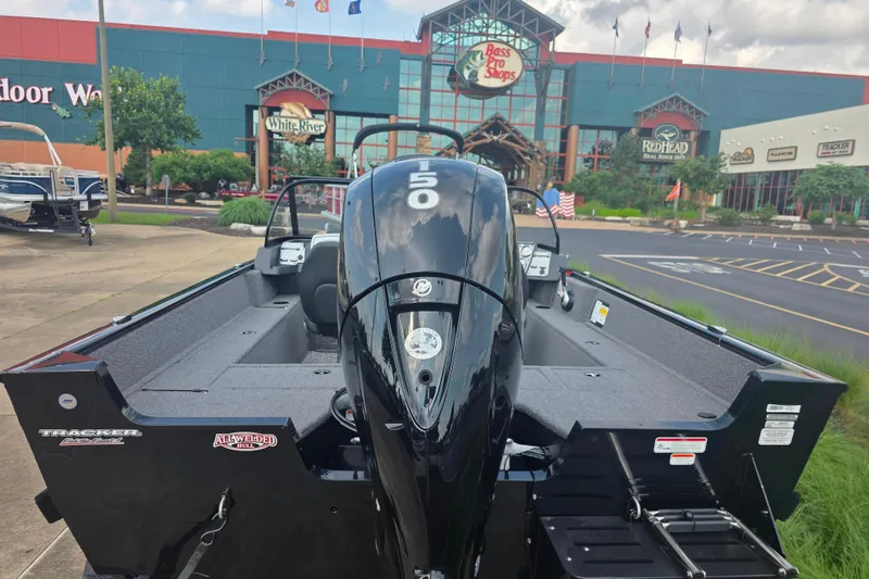 Slide: The Image of 2026 Tracker Pro Guide V-175 Combo boat displayed outside Bass Pro Shops. - 4