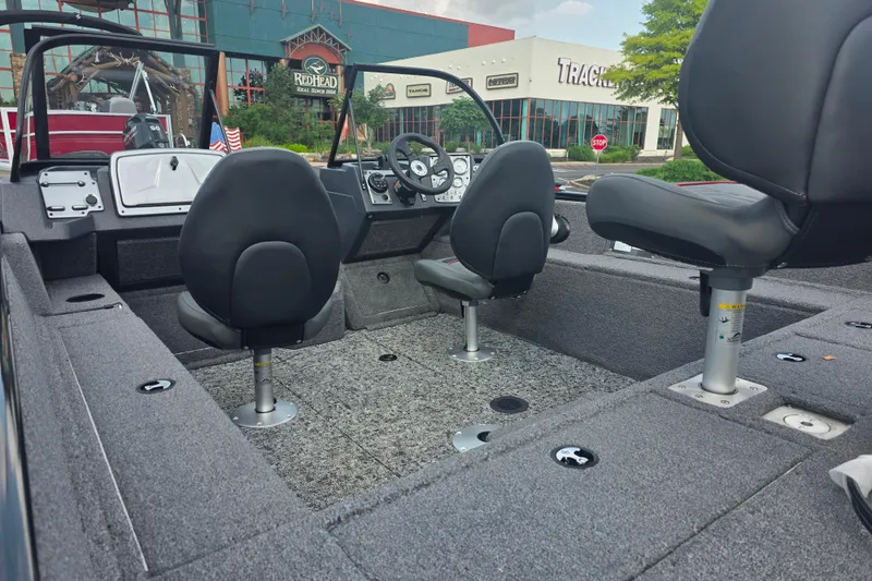 Slide: The Image of 2026 Tracker Pro Guide V-175 Combo boat interior with seating and steering wheel. - 8