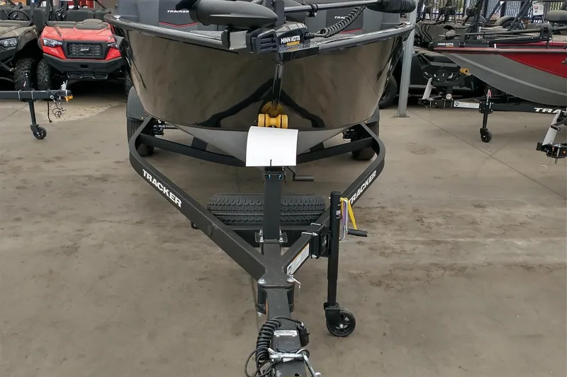 Slide: The Image of 2026 Tracker Pro Guide V-175 Combo boat on trailer in showroom. - 2