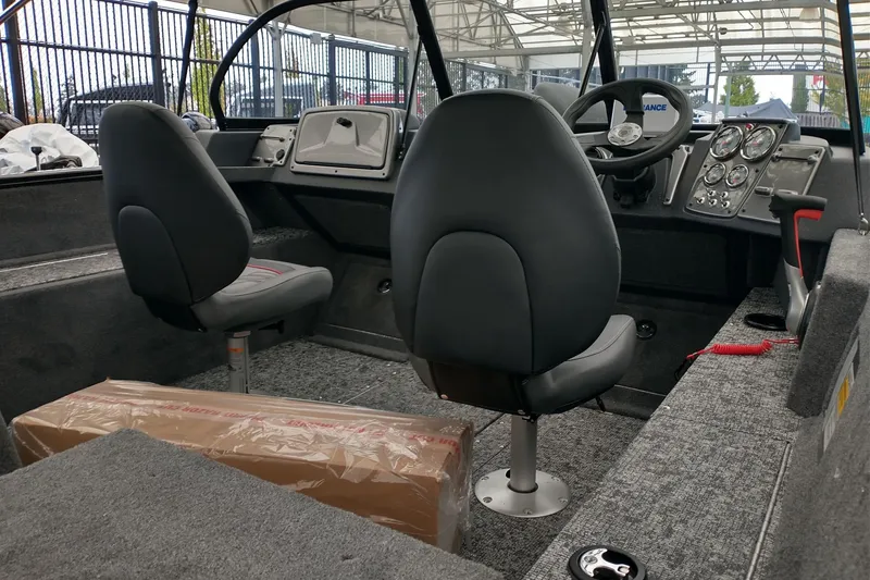 Slide: The Image of 2026 Tracker Pro Guide V-175 Combo boat interior with dual seats and control panel. - 4