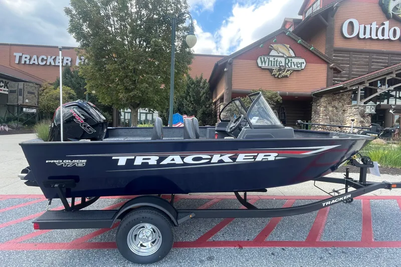 The Image of 2026 Tracker Pro Guide V-175 Combo boat on trailer, outdoor store background, trade-in offer. - 0
