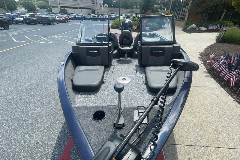 Slide: The Image of 2026 Tracker Pro Guide V-175 Combo boat with powerful outboard motor, parked outdoors. - 2