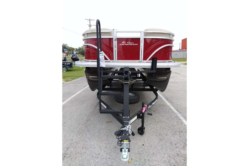 Slide: The Image of 2025 Sun Tracker Party Barge 22 RF XP3 on trailer, parked outdoors. - 3