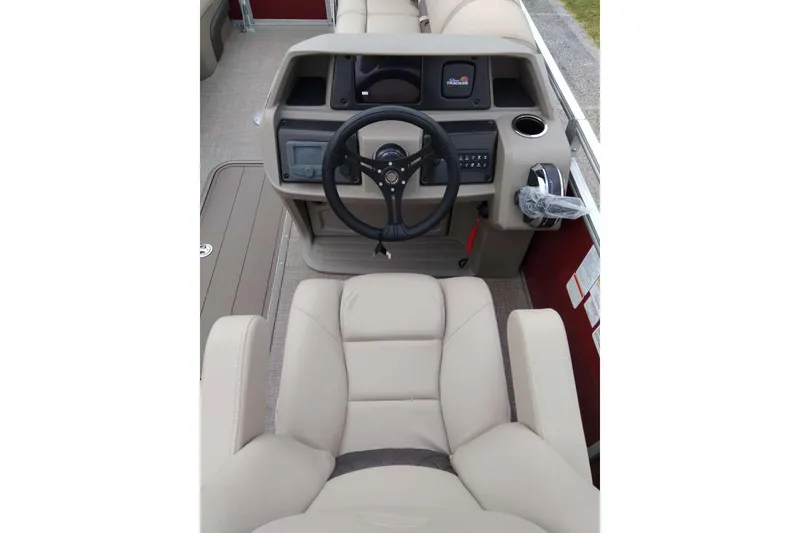 Slide: The Image of 2025 Sun Tracker Party Barge 22 RF XP3 helm with beige seating and steering wheel. - 5