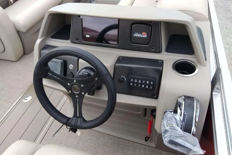 Slide: The Image of 2025 Sun Tracker Party Barge 22 RF XP3 steering console with controls and cup holder. - 6