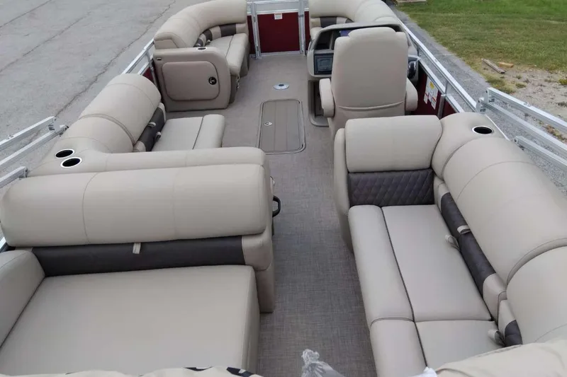 Slide: The Image of 2025 Sun Tracker Party Barge 22 RF XP3 interior with beige seating and cup holders. - 7