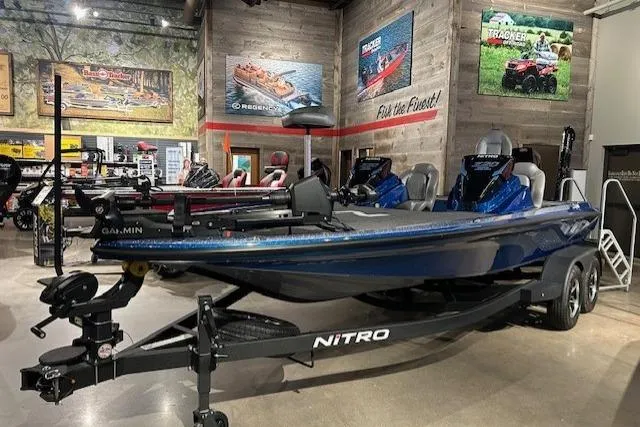 The Image of 2025 Nitro Z20 XL Pro boat displayed in a showroom with fishing equipment. - 1