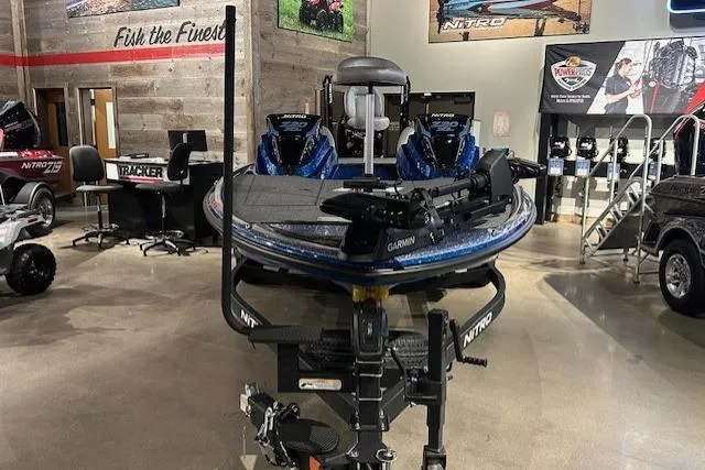 Slide: The Image of 2025 Nitro Z20 XL Pro boat displayed in a showroom with fishing equipment. - 15