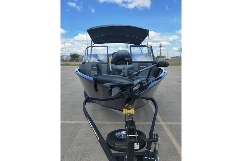 Slide: The Image of 2026 Tracker Pro Guide V-175 Combo boat on trailer, parked outdoors under blue sky. - 4