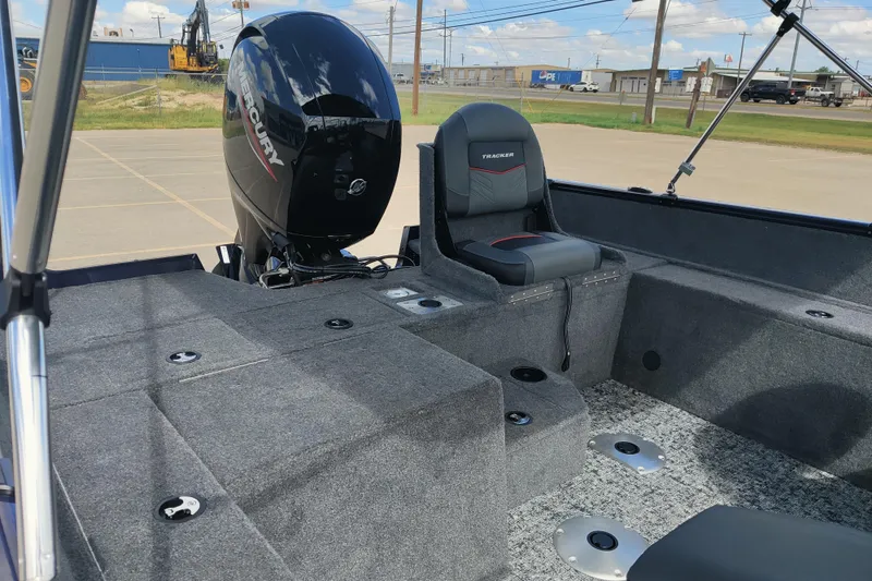 Slide: The Image of 2026 Tracker Pro Guide V-175 Combo boat interior with Mercury engine, featuring seating and storage. - 5
