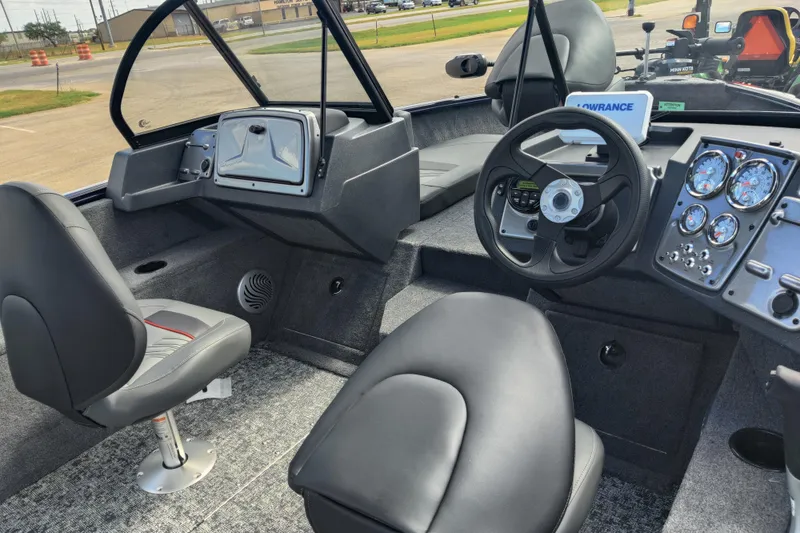 Slide: The Image of 2026 Tracker Pro Guide V-175 Combo boat interior with steering wheel and dashboard controls. - 8