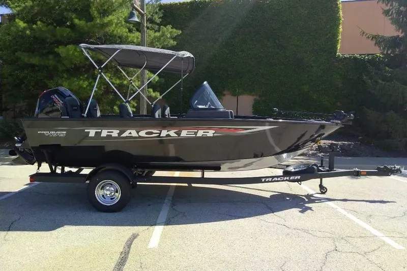 The Image of 2026 Tracker Pro Guide V-175 Combo boat on trailer, parked outdoors. - 0