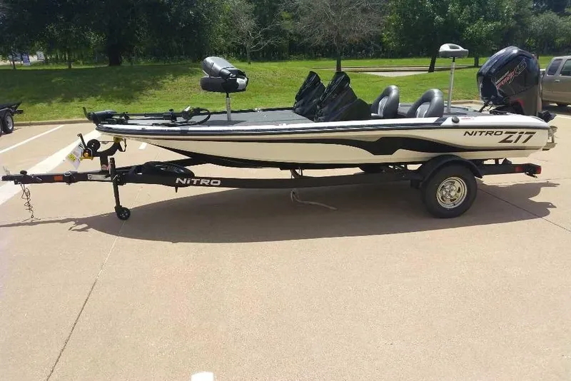 The Image of 2025 Nitro Z17 fishing boat on trailer in sunny outdoor setting. - 0