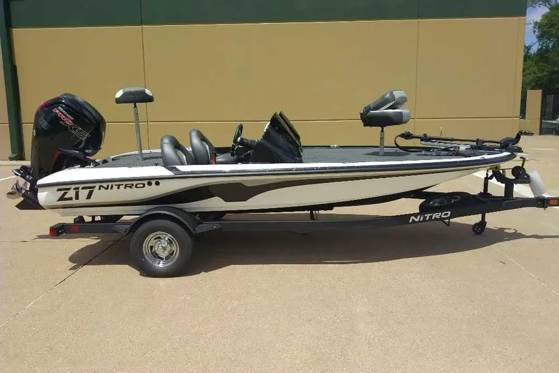 Slide: The Image of 2025 Nitro Z17 fishing boat on trailer, side view, parked outdoors. - 1