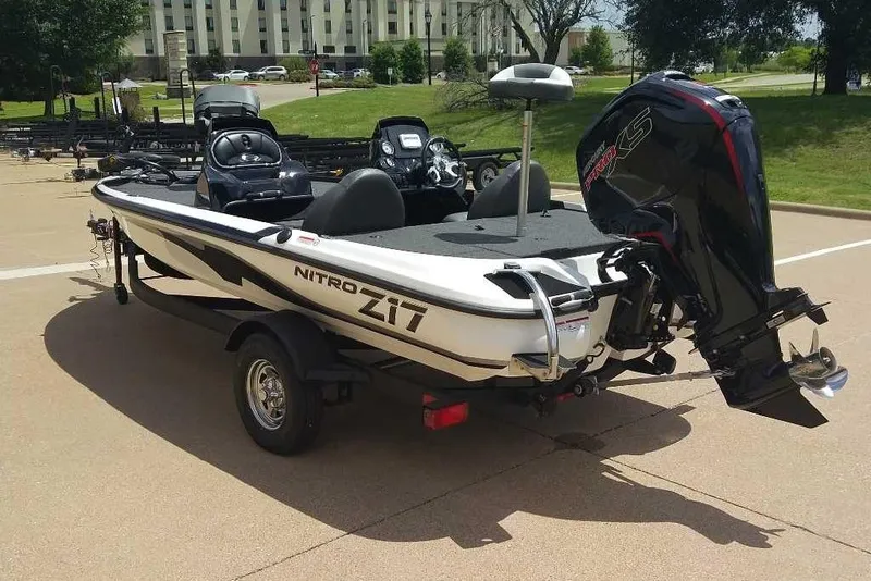 Slide: The Image of 2025 Nitro Z17 boat with powerful outboard motor, parked on a trailer in a sunny lot. - 10