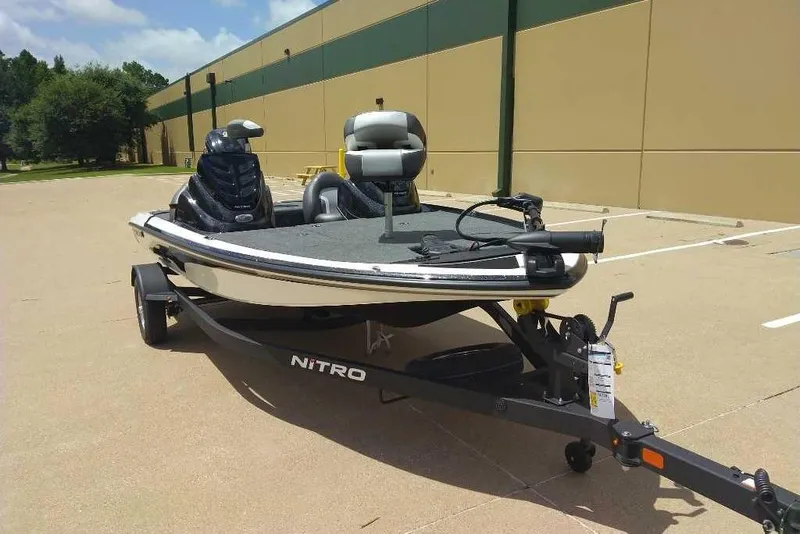 Slide: The Image of 2025 Nitro Z17 boat on trailer in parking lot, sunny day. - 3