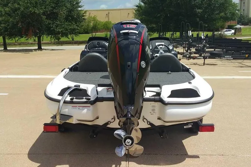 Slide: The Image of 2025 Nitro Z17 boat with powerful outboard motor, parked outdoors on a sunny day. - 9