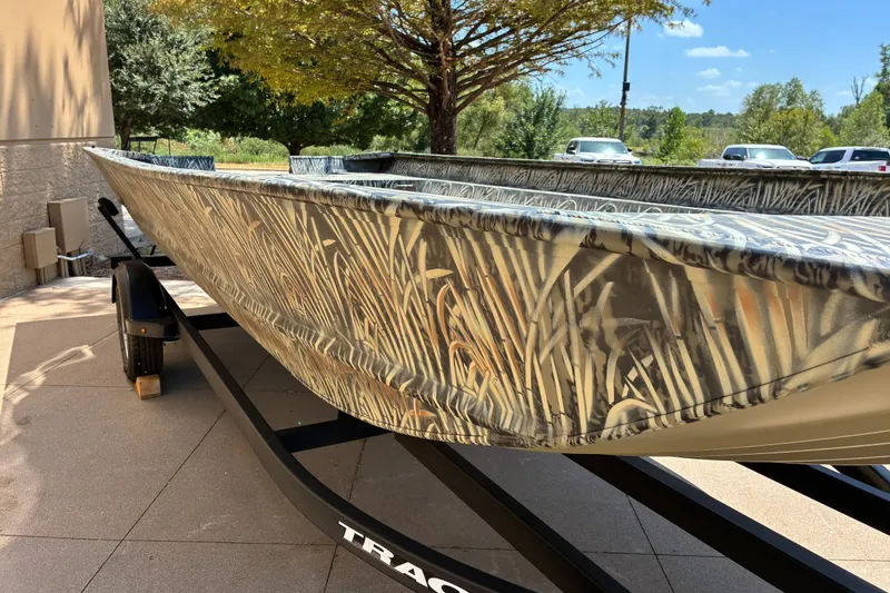 The Image of 2025 Tracker Grizzly 2072 Utility boat with camouflage design on a trailer. - 0