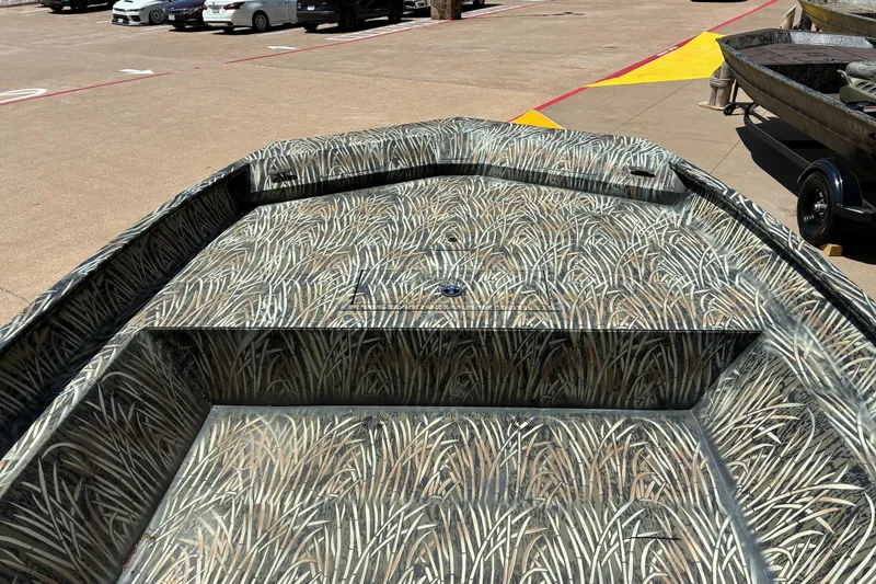 Slide: The Image of 2025 Tracker Grizzly 2072 Utility boat with camouflage pattern in a parking lot. - 13