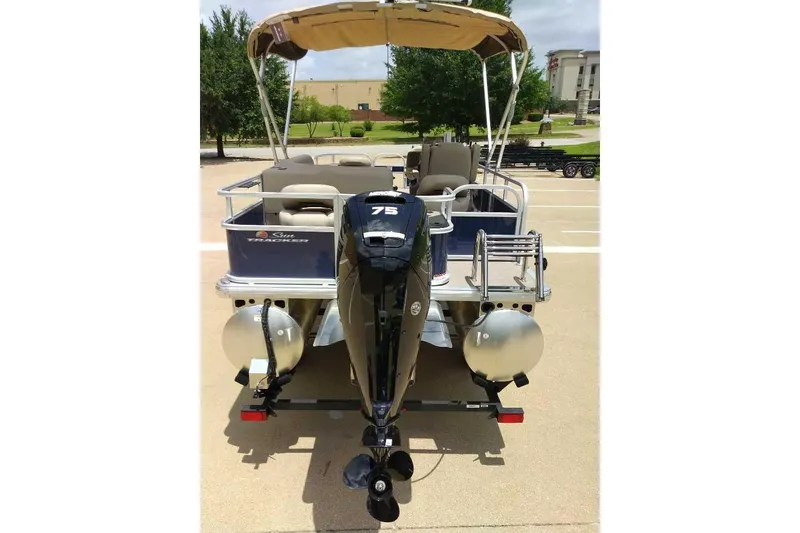Slide: The Image of 2025 Sun Tracker Bass Buggy 18 DLX pontoon boat with 75 HP engine, rear view. - 7
