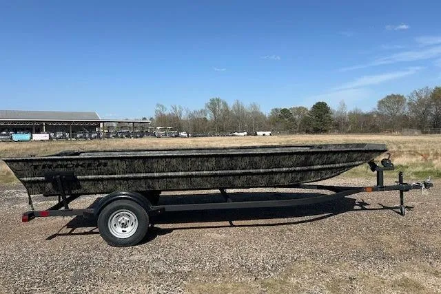 The Image of 2025 Tracker Grizzly 1860 Utility boat on trailer in open field. - 0