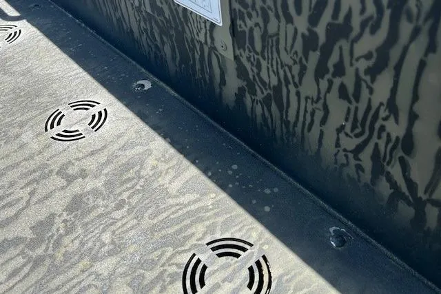 Slide: The Image of 2025 Tracker Grizzly 1860 Utility boat interior with camouflage pattern and drainage holes. - 5