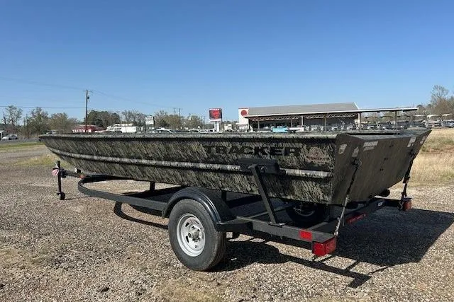Slide: The Image of 2025 Tracker Grizzly 1860 Utility boat on trailer, parked outdoors. - 8