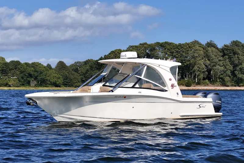 The Image of 2016 Scout 275 Dorado boat on water, with trees in the background. - 0