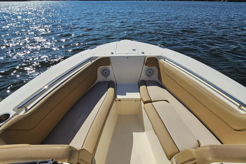 Slide: The Image of 2016 Scout 275 Dorado boat interior with tan seating on sparkling water. - 10
