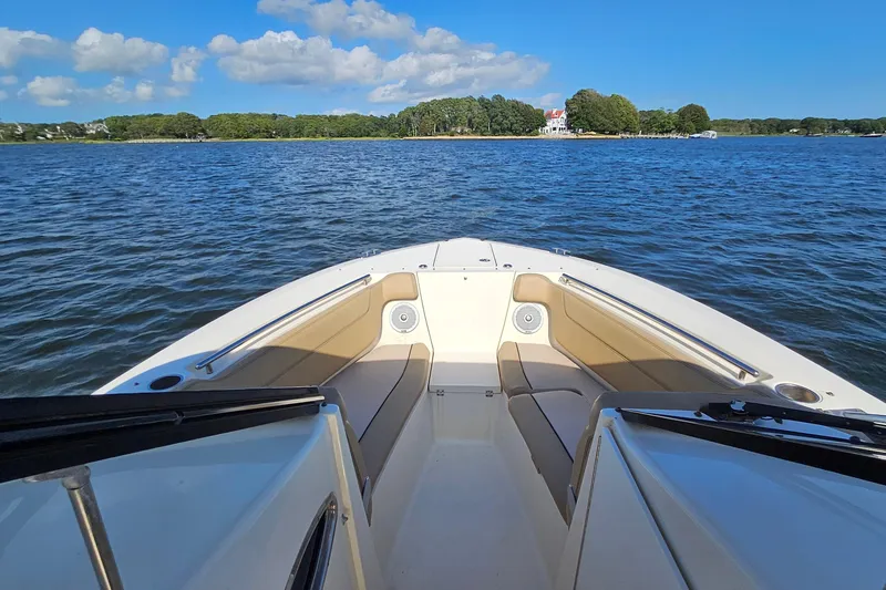 Slide: The Image of Bow view of 2016 Scout 275 Dorado boat on calm water under blue sky. - 13