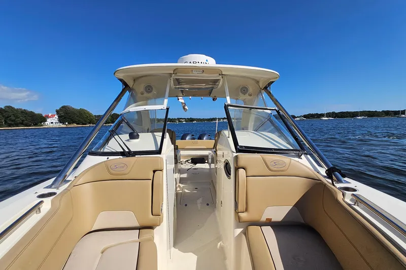 Slide: The Image of 2016 Scout 275 Dorado boat interior on a sunny day, with clear blue skies and calm waters. - 14