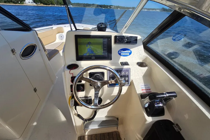 Slide: The Image of 2016 Scout 275 Dorado boat dashboard with navigation system and steering wheel. - 17