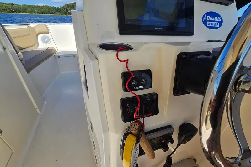 Slide: The Image of 2016 Scout 275 Dorado boat dashboard with Garmin display and Yamaha controls. - 20