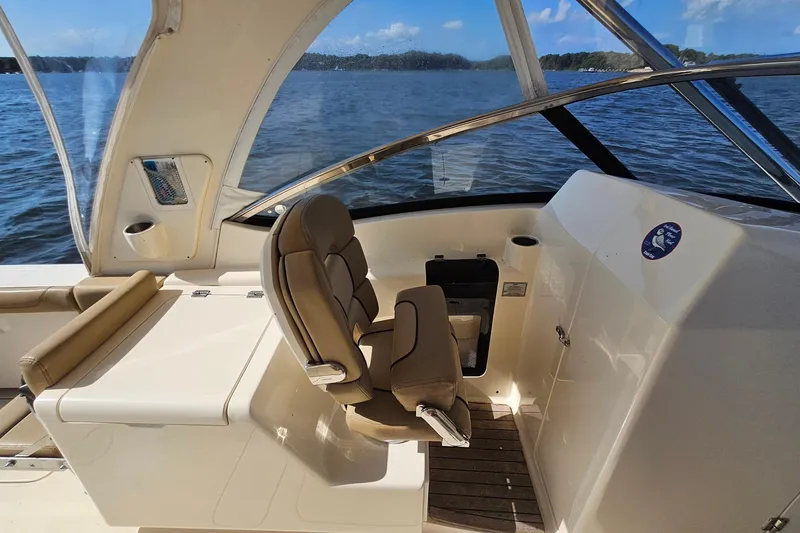 Slide: The Image of 2016 Scout 275 Dorado boat interior with helm seat and water view. - 21
