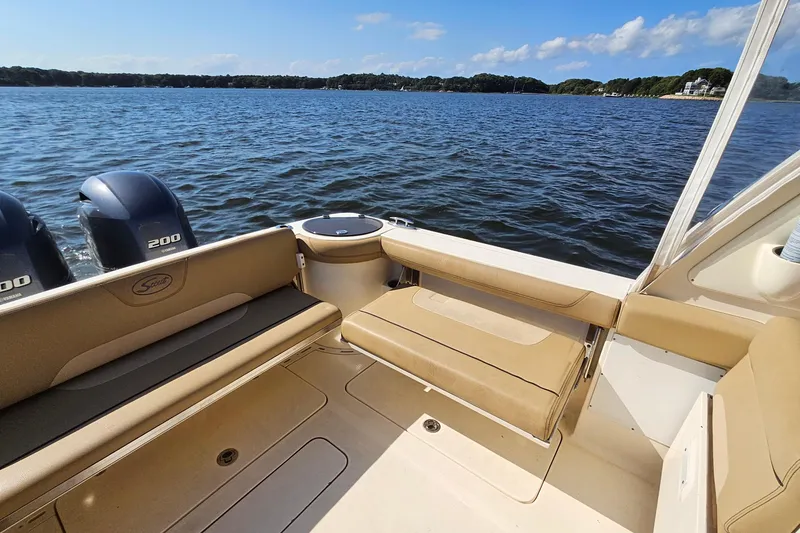 Slide: The Image of 2016 Scout 275 Dorado boat interior with twin engines on a sunny day. - 27